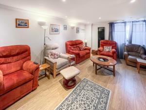 a living room with red furniture and a table at Turner Villa in Ramsgate