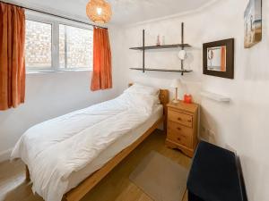 a bedroom with a bed and a desk and a window at Turner Villa in Ramsgate