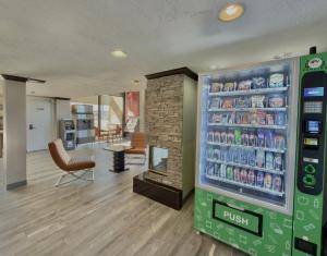 a soda machine in a store with a drink cooler at Discovery Inn in Midvale