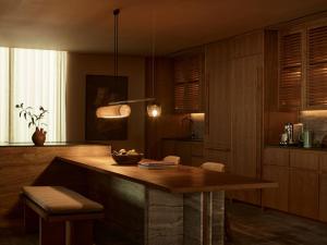 a kitchen with a large wooden table and chairs at Rosewood Mandarina in Monteón +44 photos