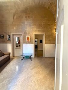 a living room with a couch and a table at Dimora 400 - nel cuore del Centro Storico di Lecce in Lecce +6 photos