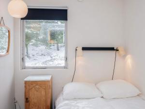 a bedroom with a bed and a window at 4 person holiday home in Blåvand in Blåvand