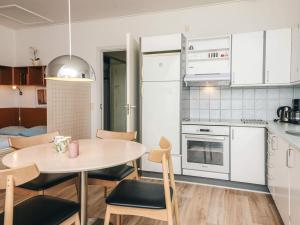 a kitchen and dining room with a table and chairs at 4 person holiday home on a holiday park in Hejls in Hejls