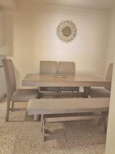 a dining room table with two chairs and a mirror at Casa 25 Centrica con 3 recamaras in Hermosillo +21 photos