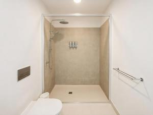 a bathroom with a shower and a toilet at Mount Buller Alpine Chalet Mountain Views Sleeps up to 12 in Mount Buller +25 photos