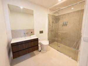 a bathroom with a shower and a sink and a toilet at Mount Buller Alpine Chalet Mountain Views Sleeps up to 12 in Mount Buller