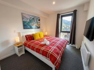 a bedroom with a bed and a large window at Mount Buller Alpine Chalet Mountain Views Sleeps up to 12 in Mount Buller