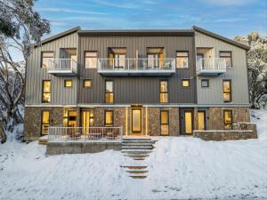 a large house in the snow in the winter at Mount Buller Alpine Chalet Mountain Views Sleeps up to 12 in Mount Buller