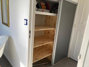 a bathroom with wooden shelves in a closet at Belle Suite Apt in Biarritz