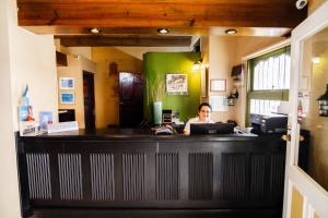 a woman sitting at a counter in a office at Hotel Petén Express in Flores +36 photos