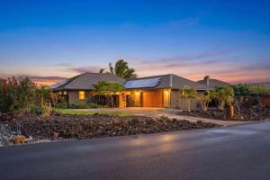 a house with a driveway in front of it at Ainamalu 9 in Waikoloa