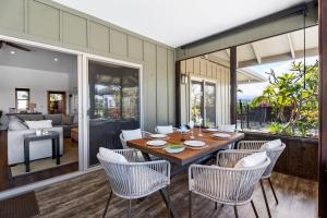 a dining room with a table and chairs at Ainamalu 9 in Waikoloa