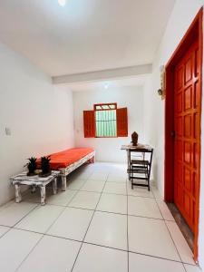 a room with a bed and a table at Suítes Xicabacana in Mata de Sao Joao