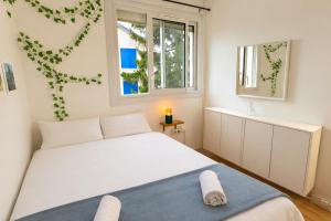 a bedroom with a white bed and two windows at Une Maison en centre ville in Cholet