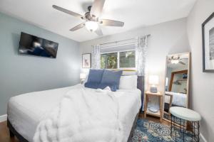 a bedroom with a white bed and a ceiling fan at Forest Home with Deck, EV Station, King Beds in Cambria