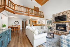 a living room with a white couch and a fireplace at Forest Home with Deck, EV Station, King Beds in Cambria