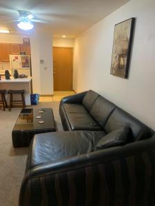 a living room with a leather couch and a table at The Upper Room in Milwaukee