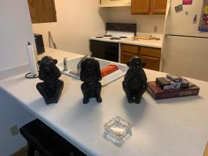 a kitchen counter with two statues of cats on it at The Upper Room in Milwaukee +1 photo