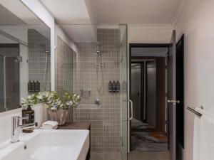 a bathroom with a sink and a shower at Mercure Brisbane Spring Hill in Brisbane