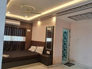 a small room with a bed and a window at BN Hotel in kolkata