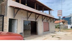 a building with a large door in front of it at Pousada Camboinha in Cabedelo