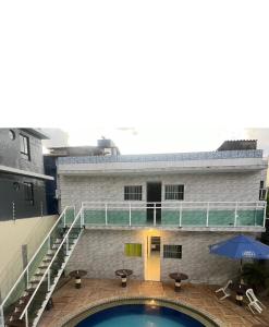 a building with a swimming pool in front of a building at Pousada Camboinha in Cabedelo +1 photo