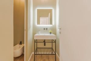 a bathroom with a sink and a mirror at Dimora del Polpo - Centro Storico in Trapani +12 photos