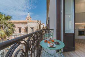 a balcony with a table with food on it at Dimora del Polpo - Centro Storico in Trapani