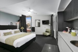 a hotel room with a bed and a desk at Menso at Southbank in Brisbane