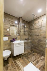 a bathroom with a shower and a toilet and a sink at Apinelo Rooms in Split