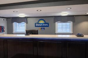a bar with a day inn sign on a wall at Days Inn by Wyndham Amherst OH - Near Cleveland Cedar Point & Lake Erie in Amherst