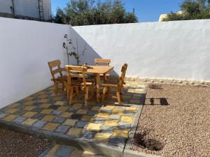 a wooden table and chairs sitting on a patio at Villa Joury in Al Maqārisah