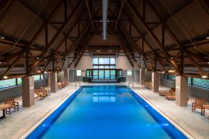 an indoor pool with blue water in a building at Alyeska Resort in Girdwood