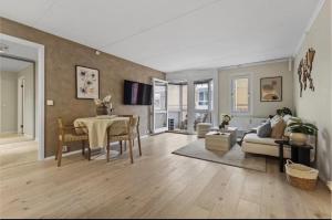 a living room with a table and a couch at Elegant apartment in Oslo