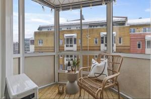 a balcony with a chair and a large window at Elegant apartment in Oslo
