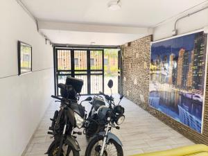 a motorcycle parked in a room with a large window at Hotel Villa Nueva Comfort in Medellín +73 photos