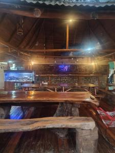 a large wooden table in a room with a bar at tatay cabinas in La Cruz