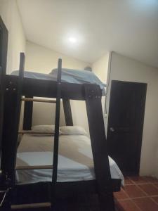 a bedroom with two bunk beds in a room at tatay cabinas in La Cruz