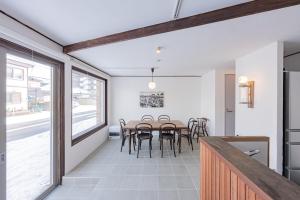 a kitchen and dining room with a table and chairs at 佐藤理容Inn in Hakodate