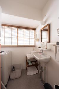 a bathroom with a sink and a mirror at 佐藤理容Inn in Hakodate +31 photos