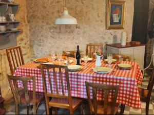a table with a red and white checkered table cloth at Cosy Castle with Pool in Onlay in Onlay