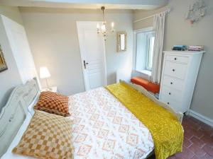 a bedroom with a bed with a yellow and white comforter at Cosy Castle with Pool in Onlay in Onlay +7 photos