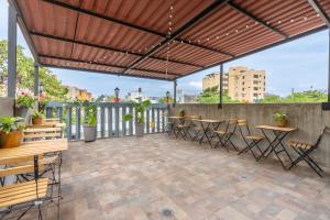 a patio with tables and chairs under awning at Casa Presentacion Adaz Hotel in Santa Marta +18 photos