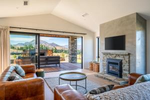 a living room with a couch and a fireplace at Carrickmore Lodge in Wanaka