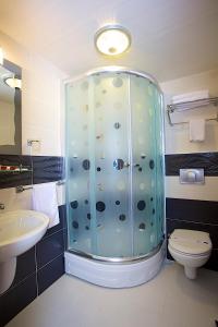 a bathroom with a shower with a toilet and a sink at Hermanos Hotel in Istanbul +62 photos