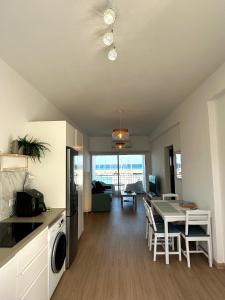 a kitchen and living room with a table and a dining room at Harbour No4 in Polis Chrysochous