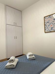 a bedroom with a bed with towels on it at Harbour No4 in Polis Chrysochous +29 photos