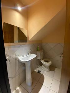 a bathroom with a sink and a toilet at cabanas nahuel in Villa General Belgrano +6 photos