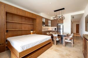 a bedroom with a large bed and a dining room at Zantamar TH06B, oceanfront in Cruz de Huanacaxtle