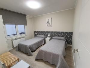 a room with two beds and a window at VUT Montse in Alcañiz +15 photos